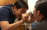 640px-US_Navy_040113-N-4614W-005_Capt._Wan_Mun_Chin_examines_a_patient_suffering_from_a_sore_throat_and_high_fever