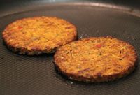Two_Morningstar_Farms_Tomato_&amp;_Basil_Pizza_veggie_burgers_on_a_frying_pan
